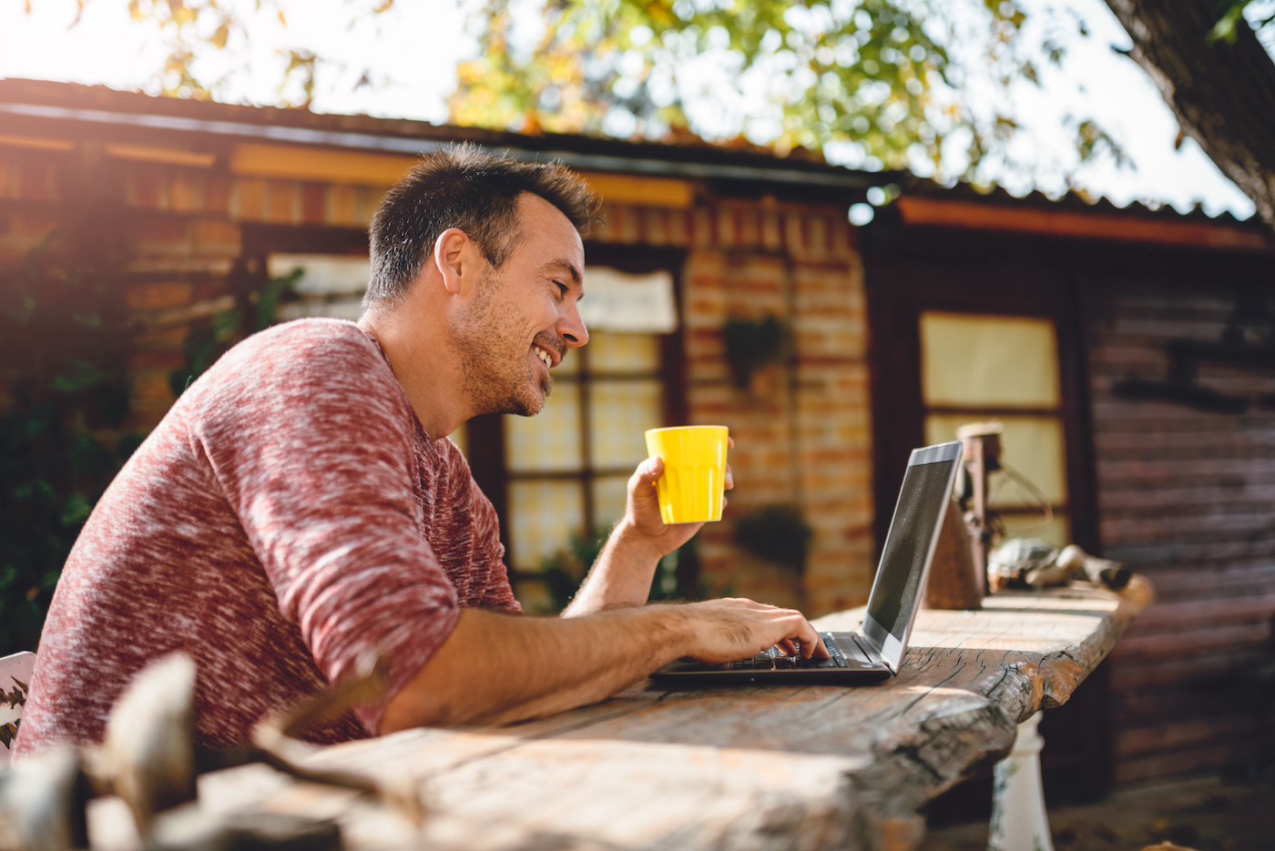Man working remotely outside on his patio representing the ease of providing IT support for small businesses