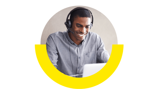 Tech support representative smiling with his headset on