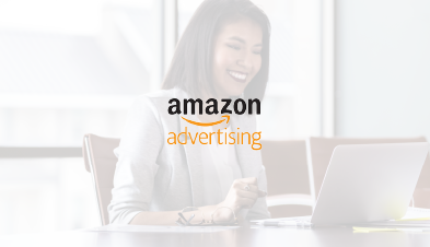 Amazon Advertising logo overlaid over image of smiling woman working on laptop