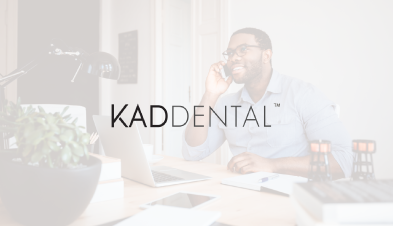 KAD Dental logo overlaid on image of remote employee working at home