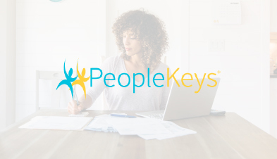 PeopleKeys logo overlaid on image of remote employee working from home