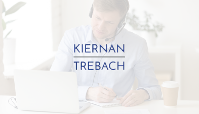 Kiernan Trebach logo, overlaid on image of employee with headset